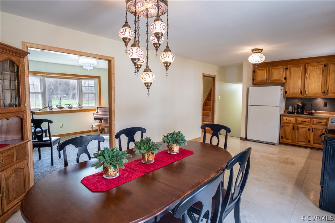 7466 Studley Road Mechanicsville, VA 23116 - Photo 12 of 34 a view of a dining room with furniture a chandelier and wooden floor