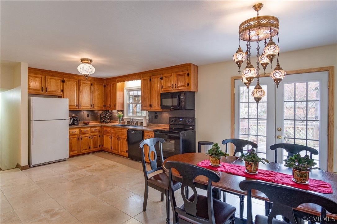 7466 Studley Road Mechanicsville, VA 23116 - Photo 13 of 34 a kitchen with stainless steel appliances granite countertop a stove refrigerator a sink dishwasher and a dining table with chairs