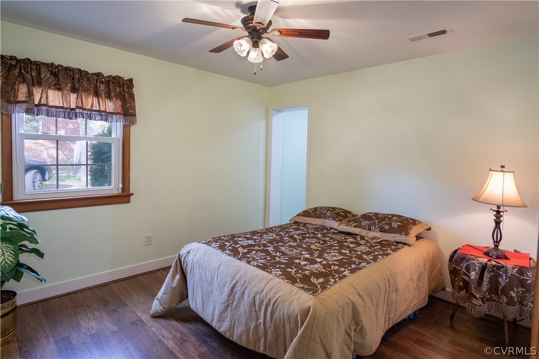 7466 Studley Road Mechanicsville, VA 23116 - Photo 19 of 34 a bedroom with a bed and wooden floor