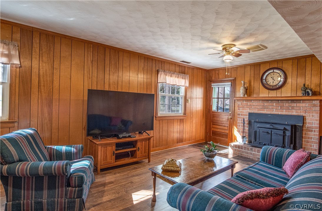 7466 Studley Road Mechanicsville, VA 23116 - Photo 26 of 34 a living room with furniture a flat screen tv and a fireplace