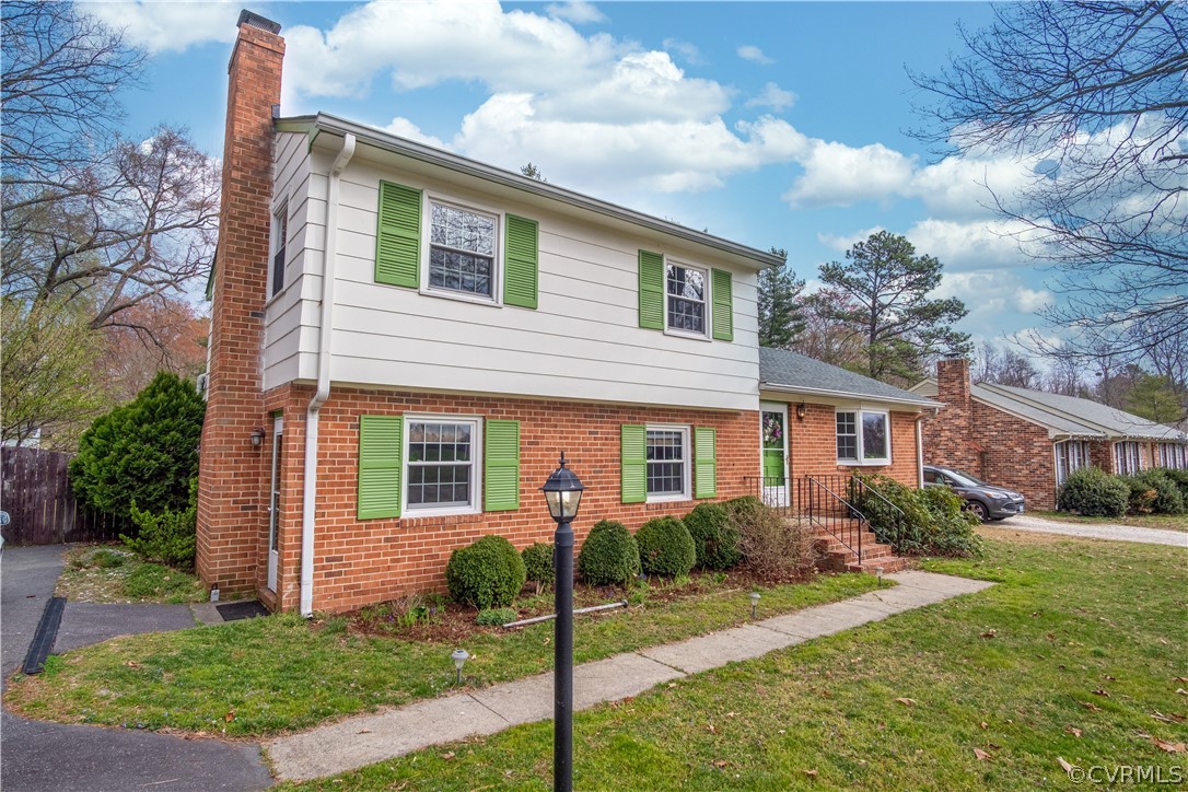 7466 Studley Road Mechanicsville, VA 23116 - Photo 3 of 34 a front view of a house with garden