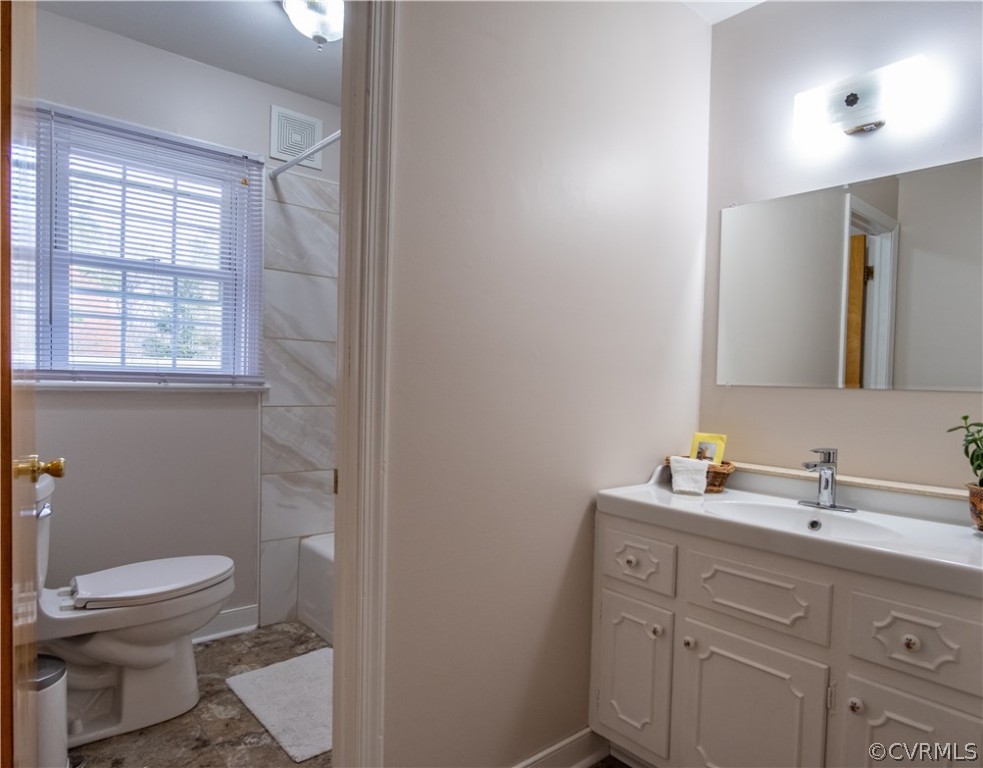 7466 Studley Road Mechanicsville, VA 23116 - Photo 34 of 34 a bathroom with a toilet a sink a vanity and mirror