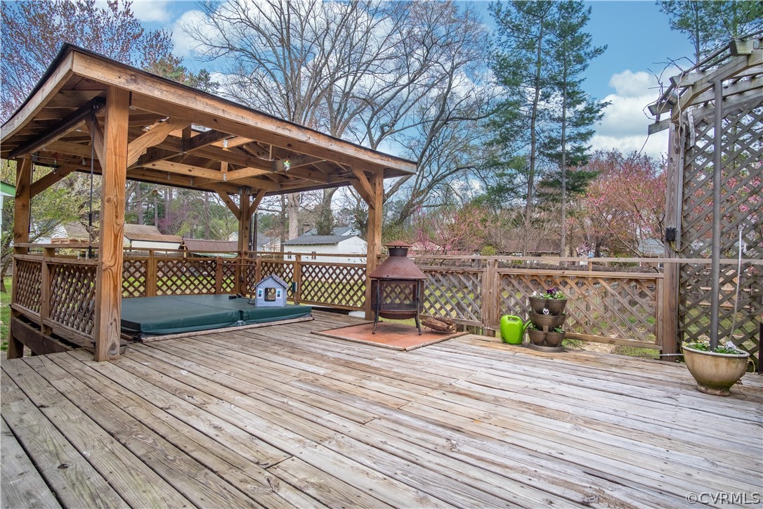 7466 Studley Road Mechanicsville, VA 23116 - Photo 9 of 34 a view of a deck with wooden floor and fence next to a yard