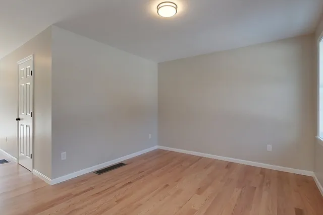a view of wooden floor in an empty room