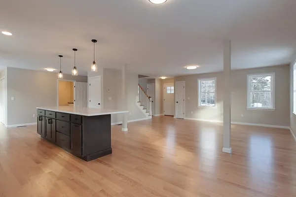 a view of kitchen with sink and windows