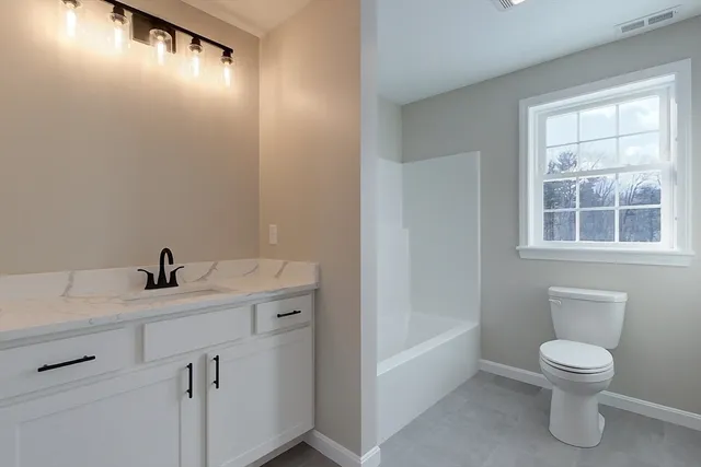 a view of white house with a snow on the road