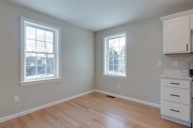 a view of kitchen and hall with wooden floor