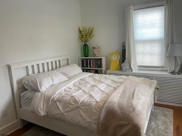 a bed sitting in a bedroom next to a window