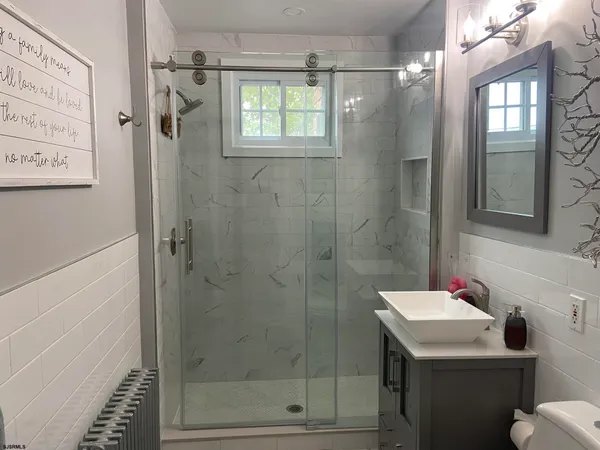 a bathroom with a sink toilet and shower