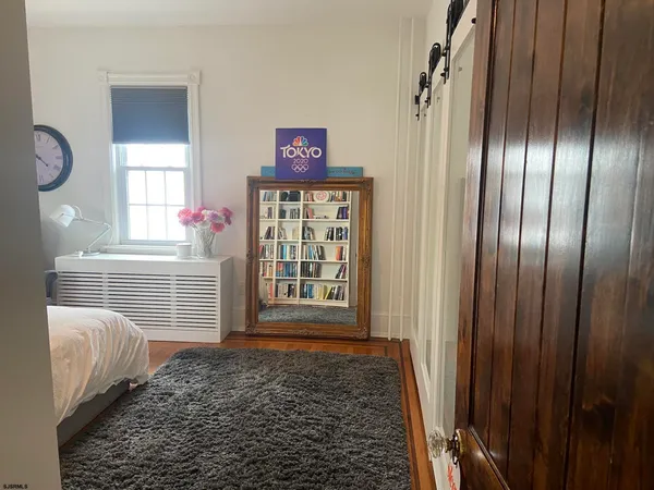 a bedroom with a bed and a mirror