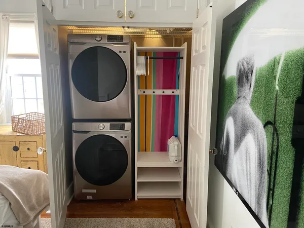 a bedroom with a bed a book shelf and a window