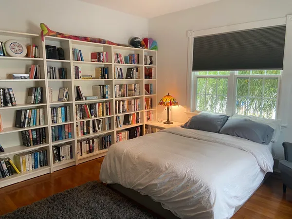 a bedroom with a bed and a chandelier