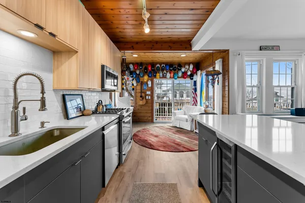 a kitchen with stainless steel appliances granite countertop a sink a stove and a counter space