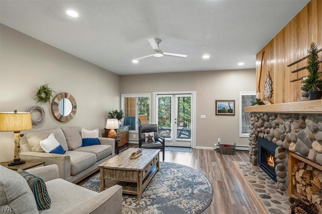 a living room with fireplace furniture and a rug