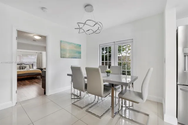 a view of a dining room with furniture and a chandelier