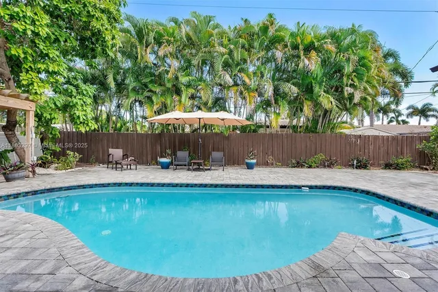 a view of a swimming pool with lounge chair