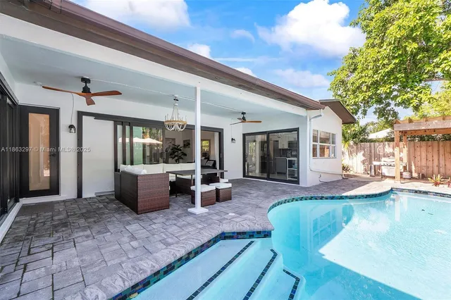 a view of a house with backyard porch and sitting area