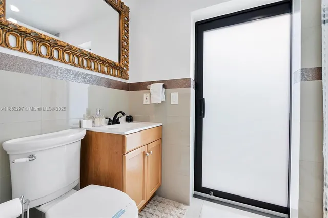 a white toilet sitting next to a bathroom sink