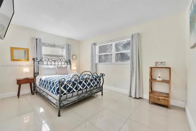 a room with a bed and a night stand in it