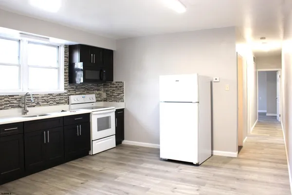 a kitchen with a refrigerator and a sink