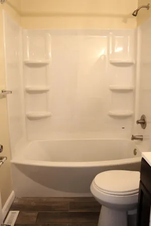 a bathroom with a toilet and a shower