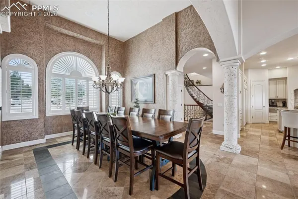 a dining room with furniture and a chandelier