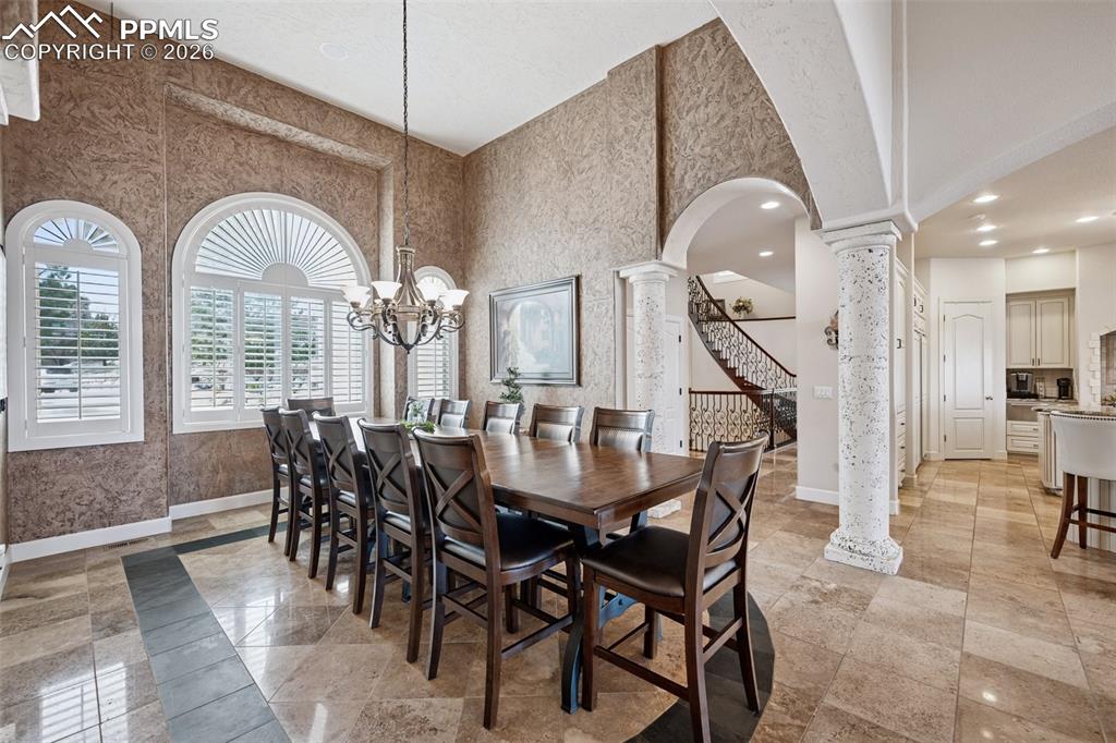 5039 Stonehill Road Colorado Springs, CO 80918 - Photo 12 of 50 a dining room with furniture and a chandelier