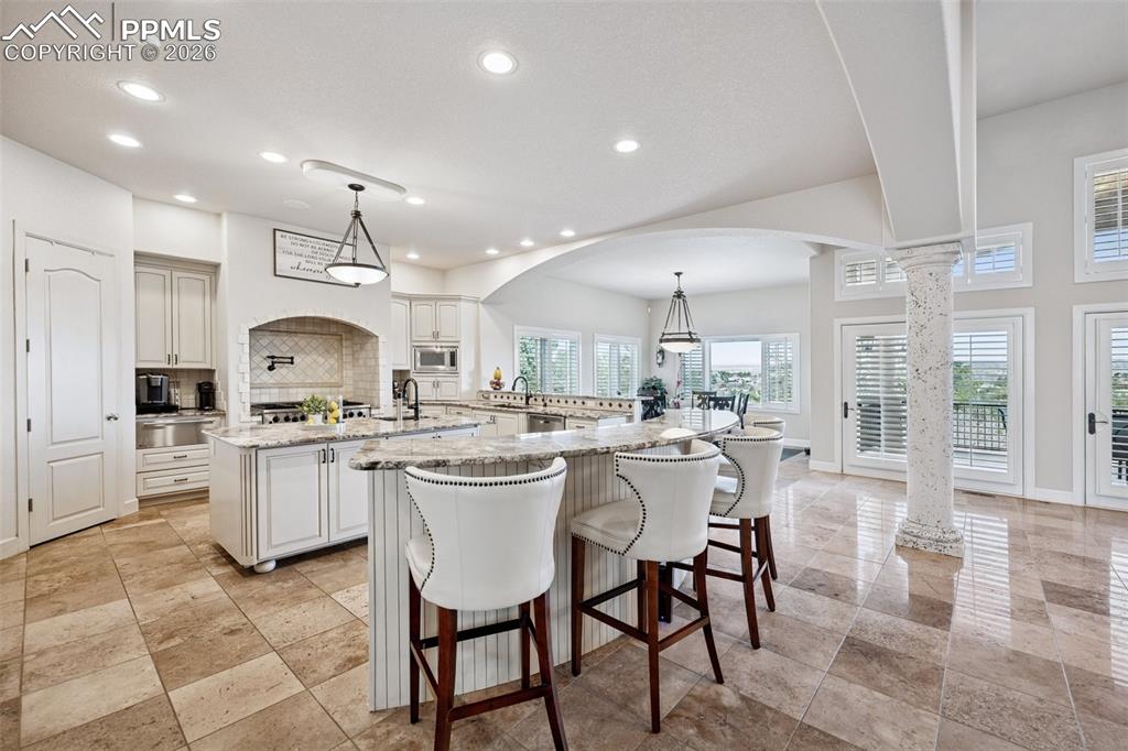 5039 Stonehill Road Colorado Springs, CO 80918 - Photo 14 of 50 a kitchen with a sink and chairs