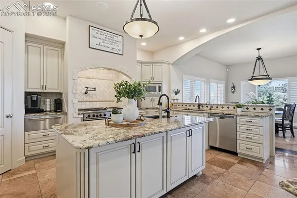 a kitchen with stainless steel appliances granite countertop a sink and cabinets