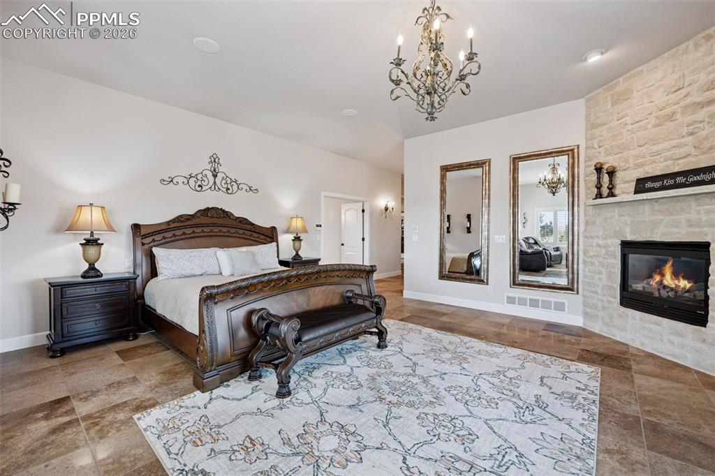 5039 Stonehill Road Colorado Springs, CO 80918 - Photo 20 of 50 a bedroom with a bed and a fireplace