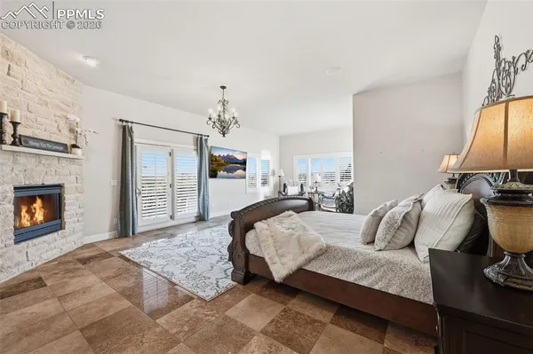 a bedroom with a bed and a fireplace