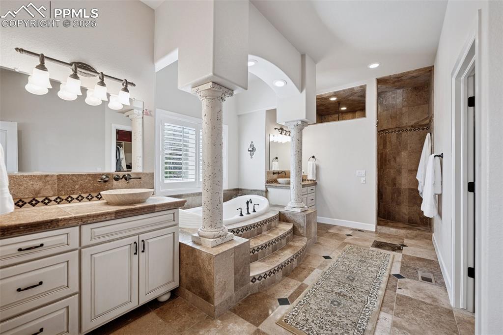 5039 Stonehill Road Colorado Springs, CO 80918 - Photo 23 of 50 a spacious bathroom with a double vanity sink mirror and shower
