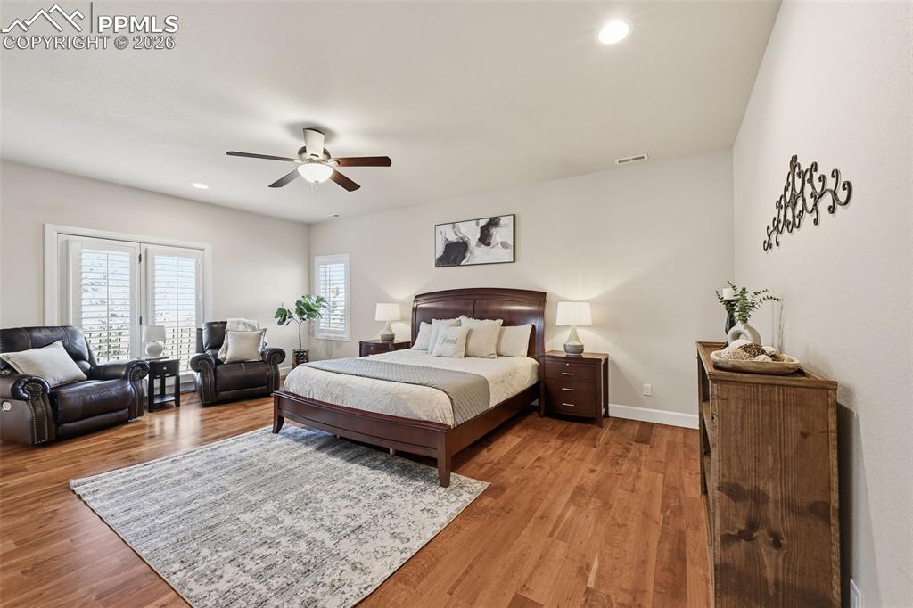 5039 Stonehill Road Colorado Springs, CO 80918 - Photo 27 of 50 a spacious bedroom with a bed a couch and a dresser