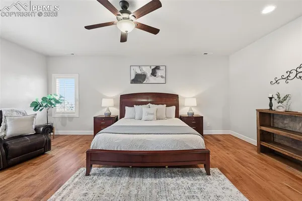 a bedroom with a bed chandelier and a window