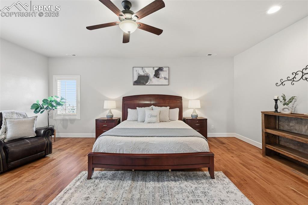 5039 Stonehill Road Colorado Springs, CO 80918 - Photo 28 of 50 a bedroom with a bed chandelier and a window