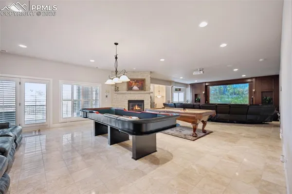 a living room with furniture a table and kitchen view
