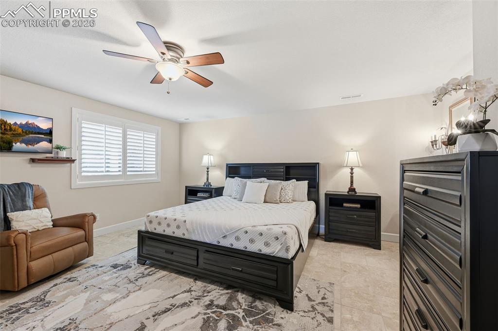 5039 Stonehill Road Colorado Springs, CO 80918 - Photo 38 of 50 a bedroom with a bed and a couch
