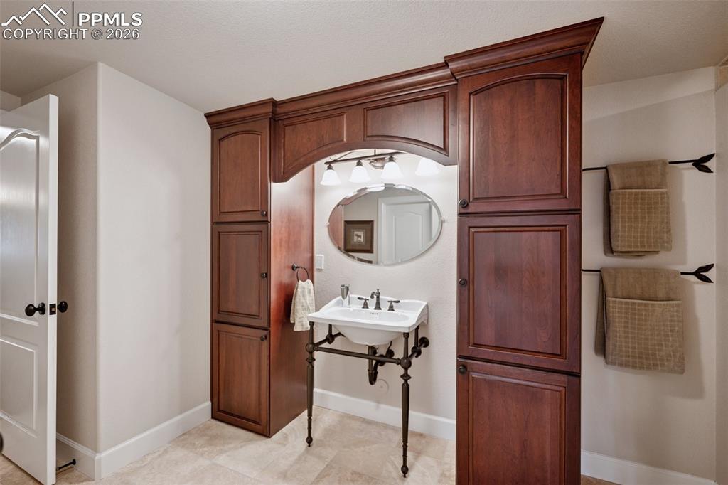 5039 Stonehill Road Colorado Springs, CO 80918 - Photo 40 of 50 a bathroom with a sink and a mirror