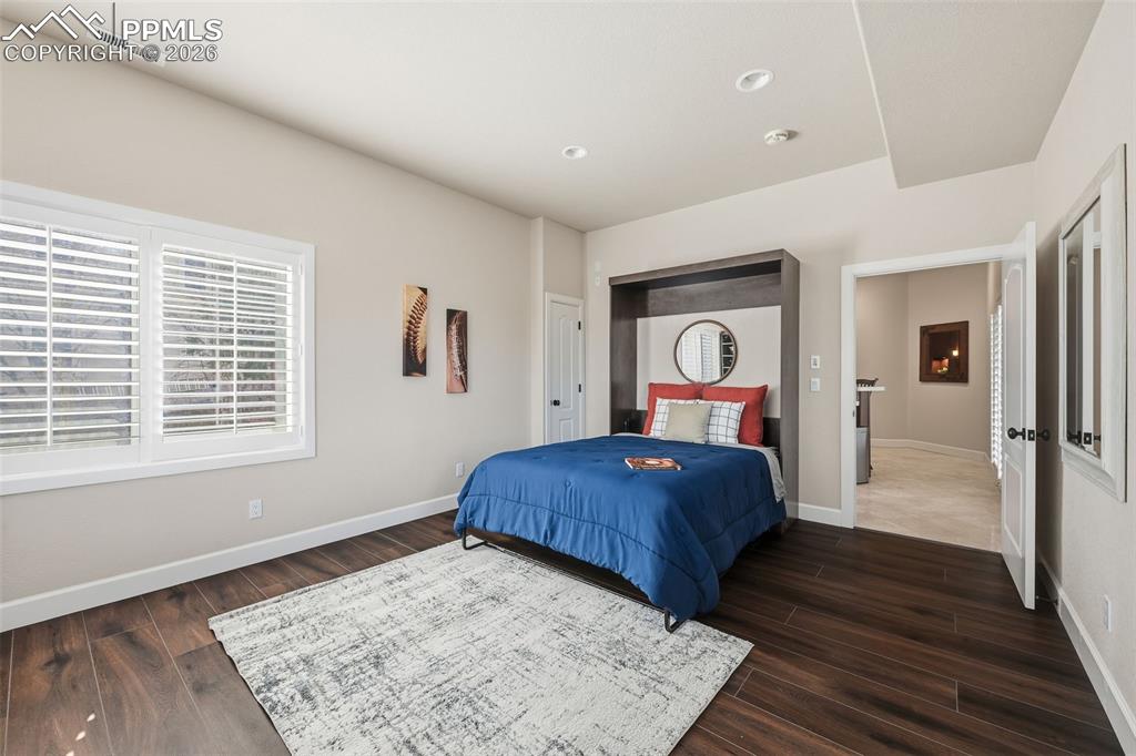 5039 Stonehill Road Colorado Springs, CO 80918 - Photo 42 of 50 a bedroom with a large bed and a window