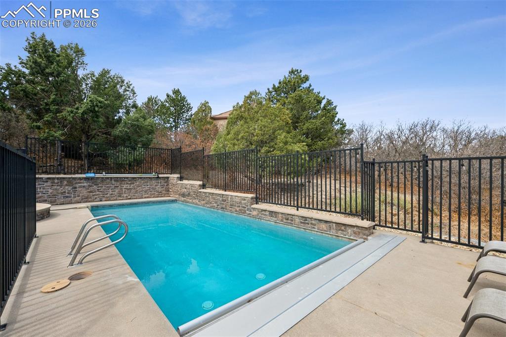 5039 Stonehill Road Colorado Springs, CO 80918 - Photo 48 of 50 a view of a swimming pool with a patio