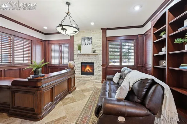 a living room with furniture fireplace and window