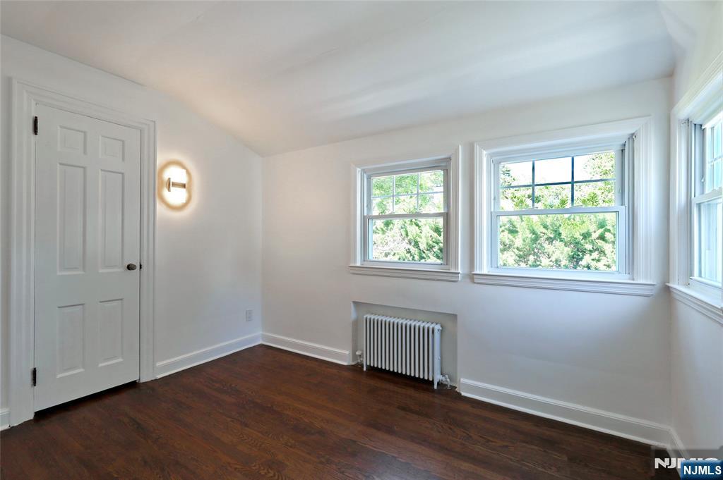 55 Forest Road Demarest, NJ 07627 - Photo 14 of 27 an empty room with wooden floor and windows