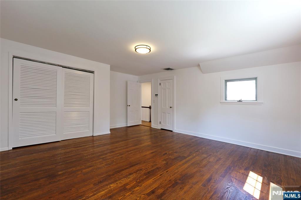 55 Forest Road Demarest, NJ 07627 - Photo 16 of 27 a view of empty room with wooden floor and fan
