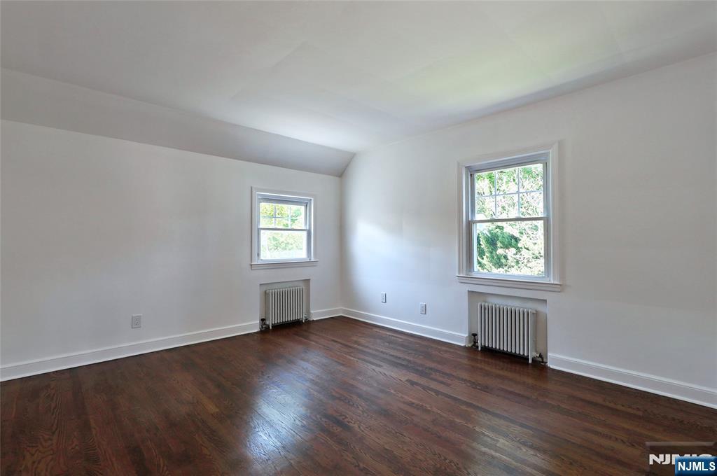 55 Forest Road Demarest, NJ 07627 - Photo 18 of 27 an empty room with wooden floor and windows