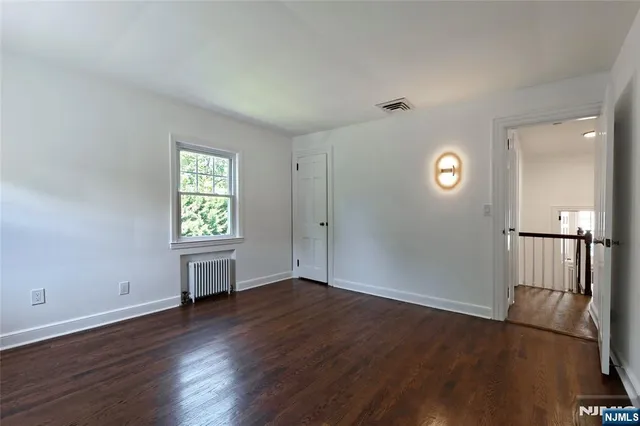 an empty room with windows and entrance