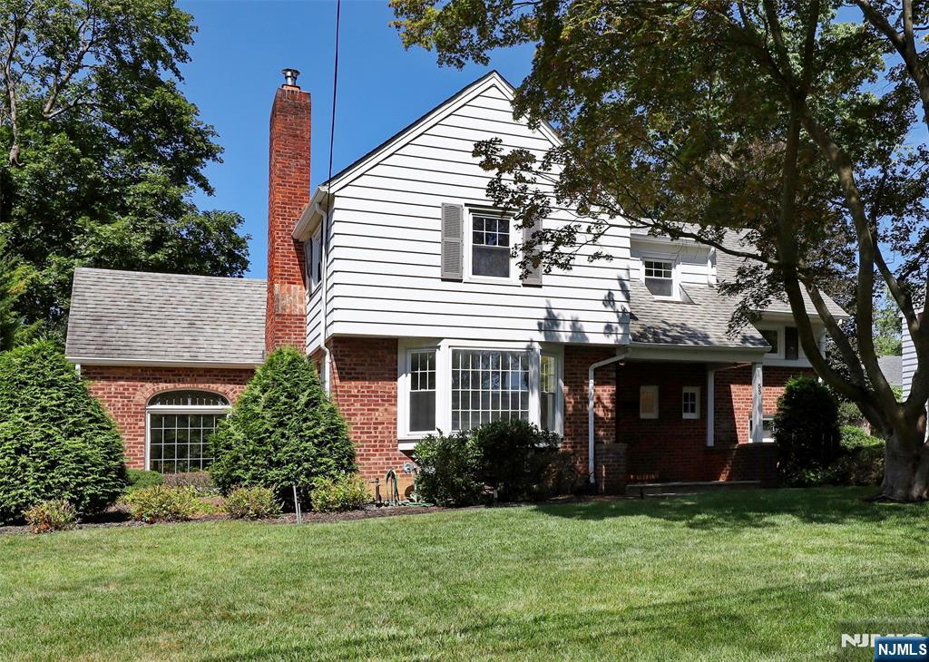 55 Forest Road Demarest, NJ 07627 - Photo 2 of 27 a front view of a house with a garden and yard