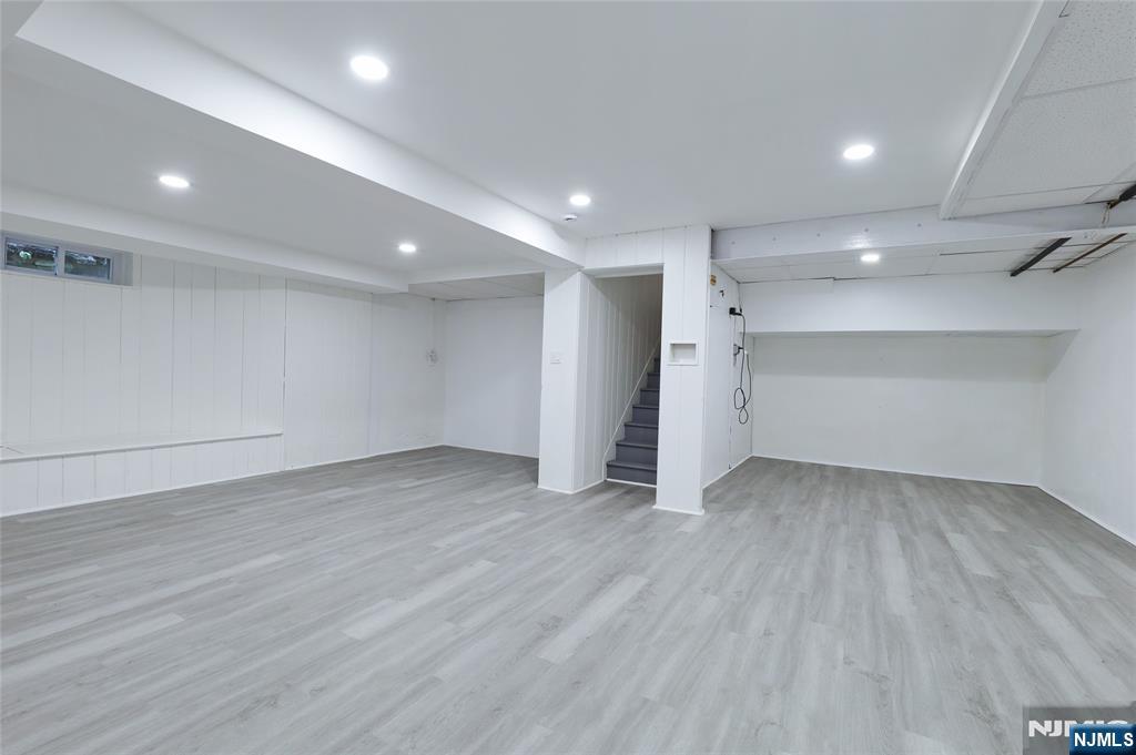 55 Forest Road Demarest, NJ 07627 - Photo 24 of 27 an empty room with wooden floor and natural light