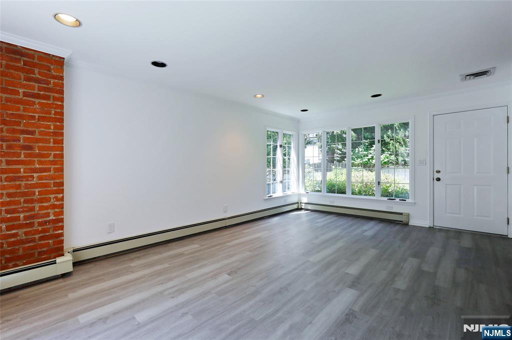 55 Forest Road Demarest, NJ 07627 - Photo 7 of 27 a view of an empty room with wooden floor and a window