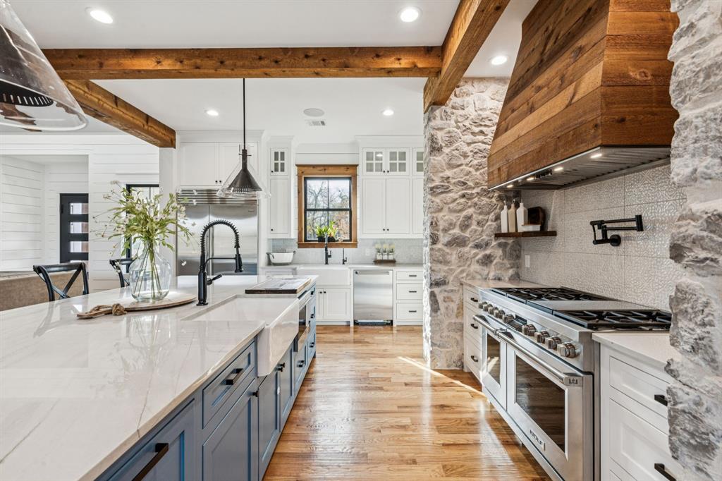 2577 Lone Star Road, Unit 1 Celina, TX 75009 - Photo 5 of 40 a large white kitchen with a stove and a sink