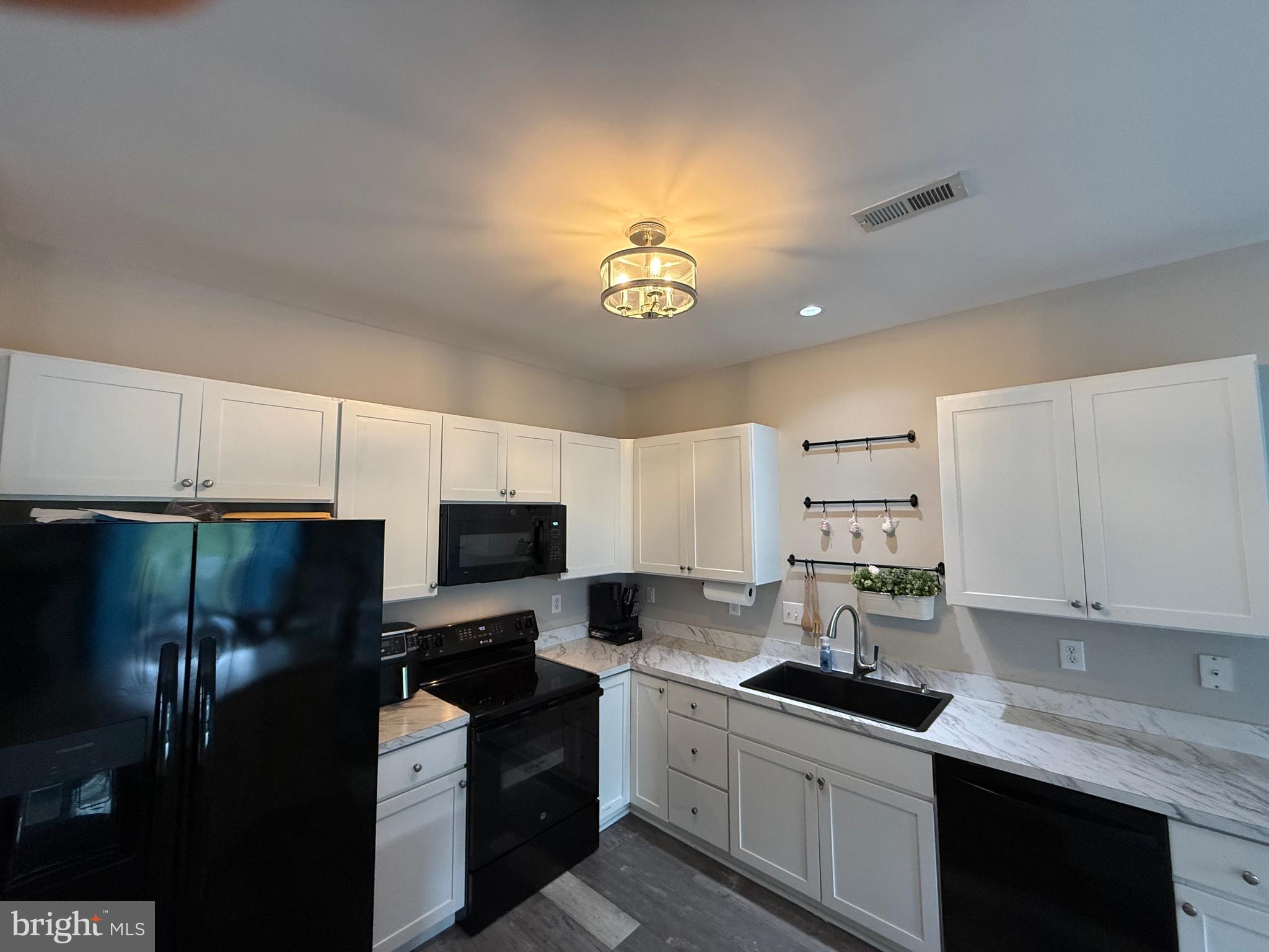 27 Bishop Pine Road Barto, PA 19504 - Photo 4 of 20 a kitchen with stainless steel appliances granite countertop a stove a sink dishwasher and a refrigerator